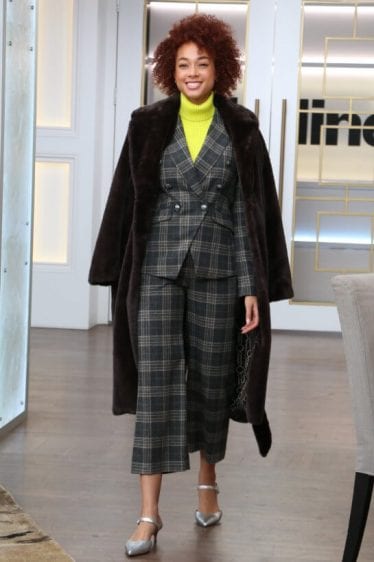 Double-breasted pant suit topped with a warm faux fur coat